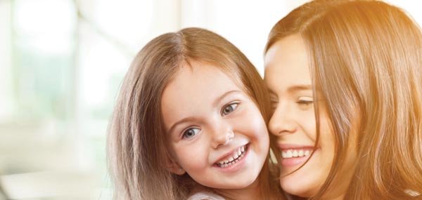 young girl smiling with mom mobile