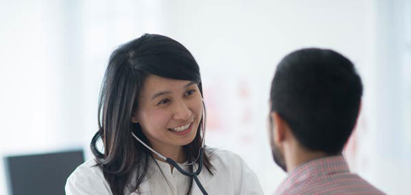 female doctor checking patient with stethoscope mobile