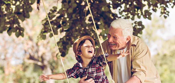 little boy on swing with grandfather mobile