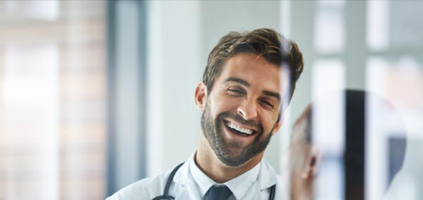 male doctor laughing with patient mobile