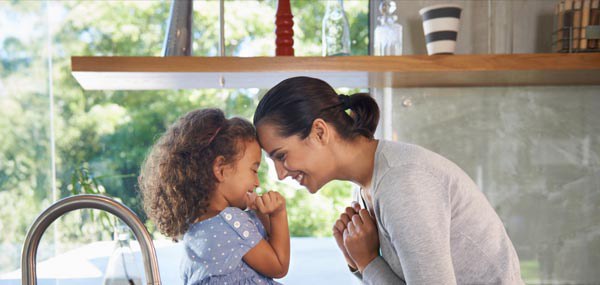 mom and daughter playing and laughing in kitchen mobile
